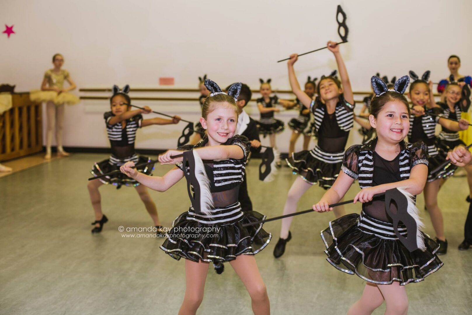 Young dancers with musical note props.