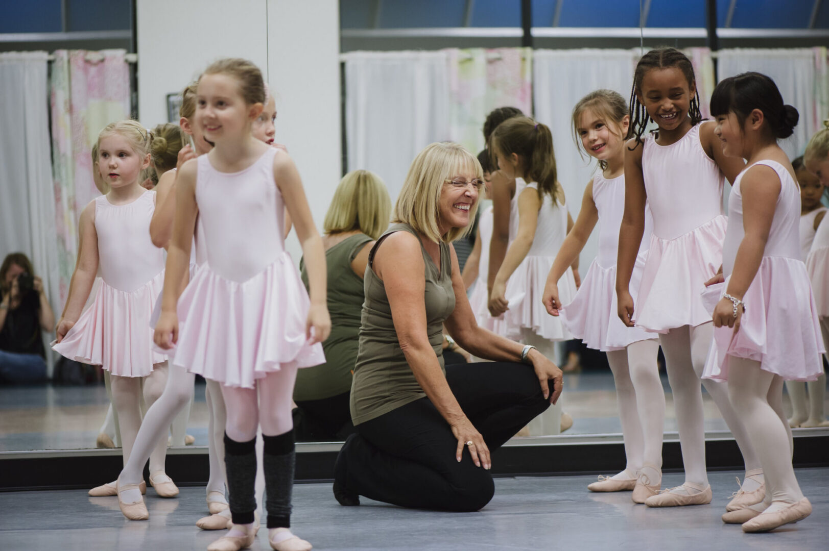 Children practicing ballet in a dance studio.
