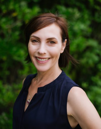 Smiling woman in a garden setting