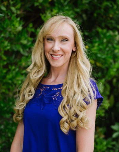 Smiling woman in blue dress outdoors