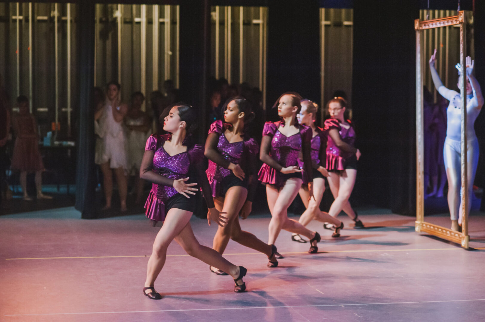 Group dance routine with mirror reflection