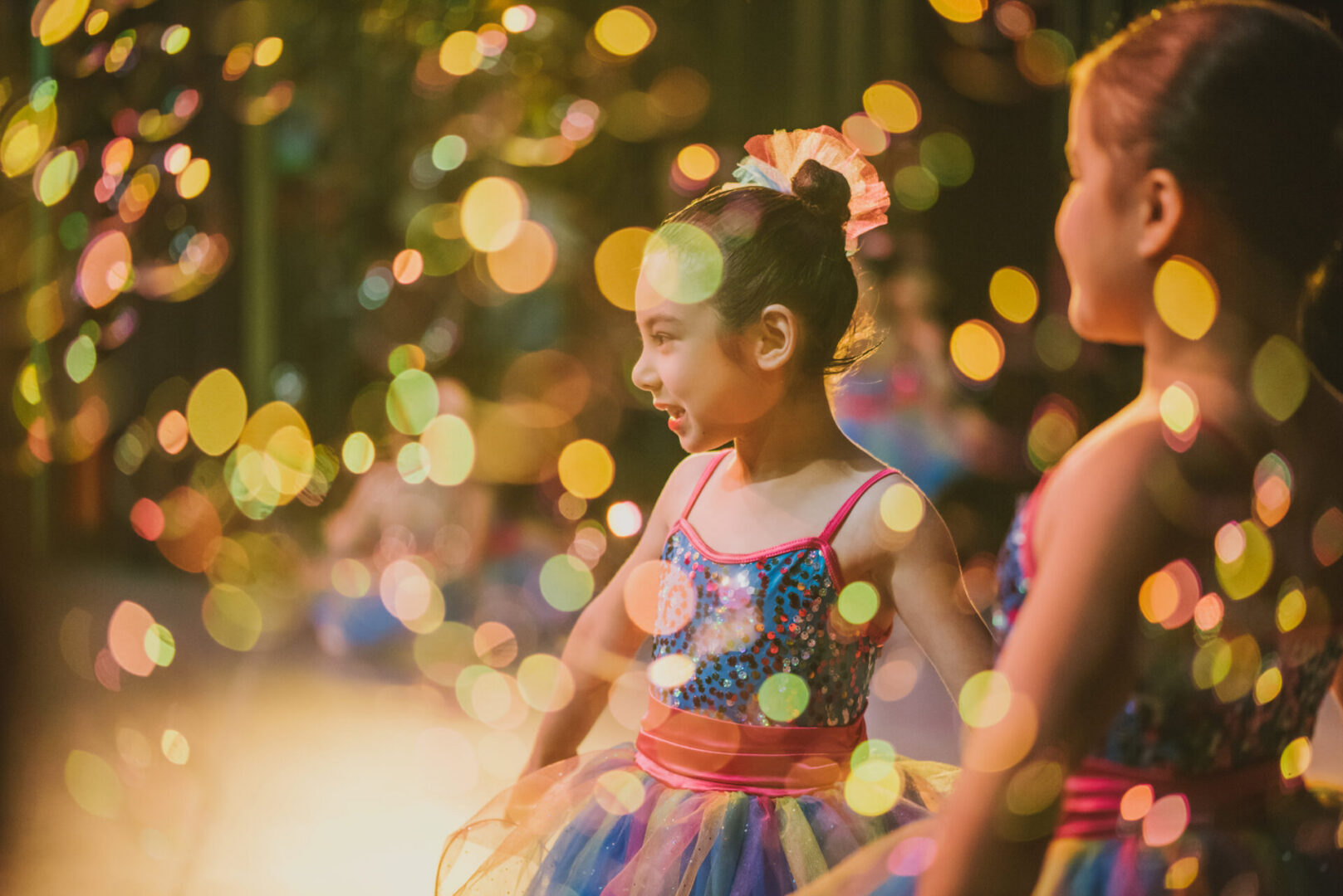 Children in colorful costumes with bokeh lights